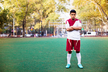 Soccer player standing in soccer field © Cavan for Adobe