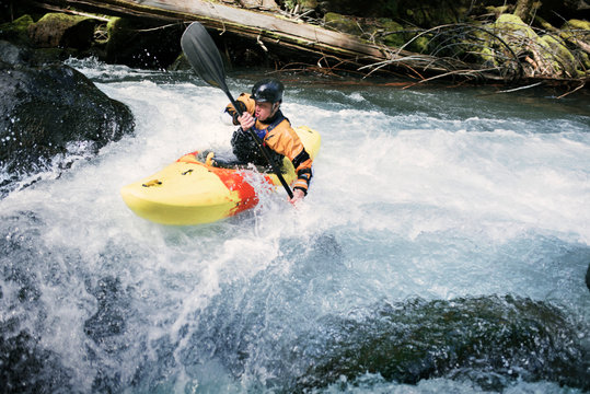 Young man canoeing in river