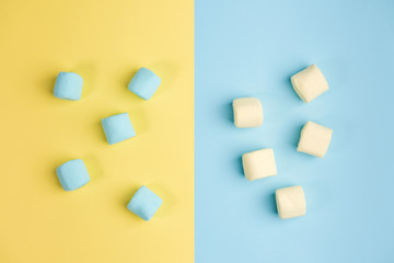 Marshmallow on blue and yellow backgrounds. Two colors. Top view.