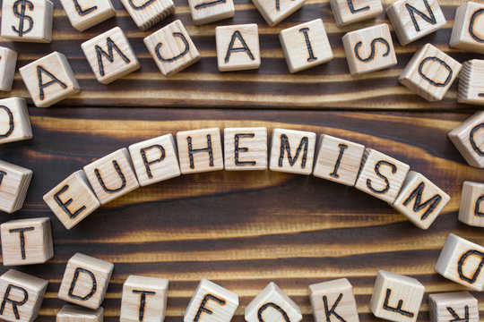 euphemism wooden cubes with letters, polite term to replace obscene or unpleasant concept, around the cubes random letters, top view on wooden background