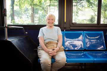Portrait of senior woman on bus © Cavan for Adobe