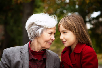 Fototapeta premium Grandmother with granddaughter (8-9) in park