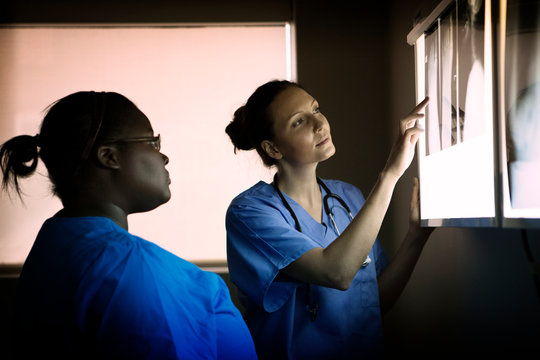 Doctors looking at x ray lightbox