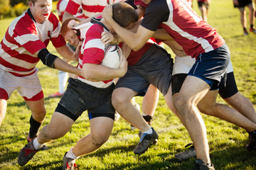 Fototapeta premium Rugby team tackling player