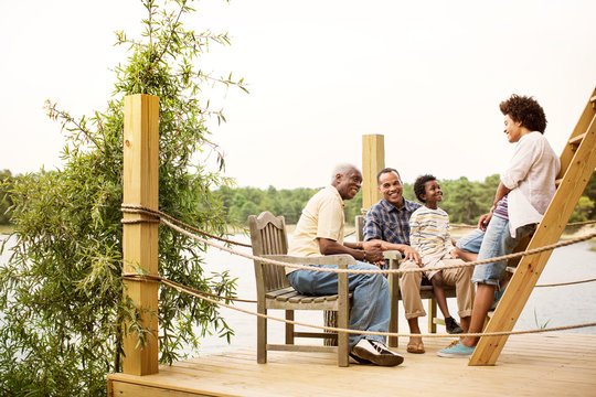 Happy family sitting on pier