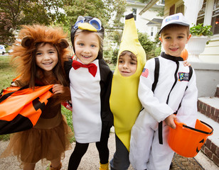 Fototapeta premium Portrait of smiling friends in Halloween costume standing outdoors