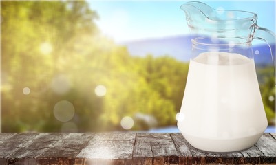 Glass jug of fresh milk isolated on white