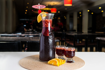 Peruvian drink: Sangria with orange and apple with a restaurant background.