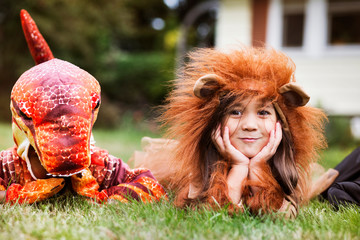 Naklejka premium Children in costumes lying on grass