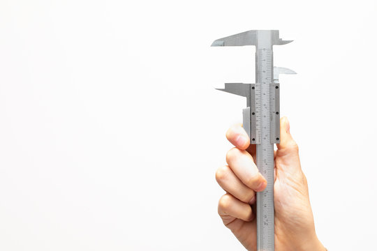 Female hand holding an open caliper to measure, isolated on wide white background like neutral space