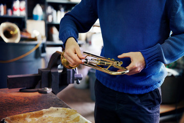 Mid-section of man holding trumpet © Cavan for Adobe