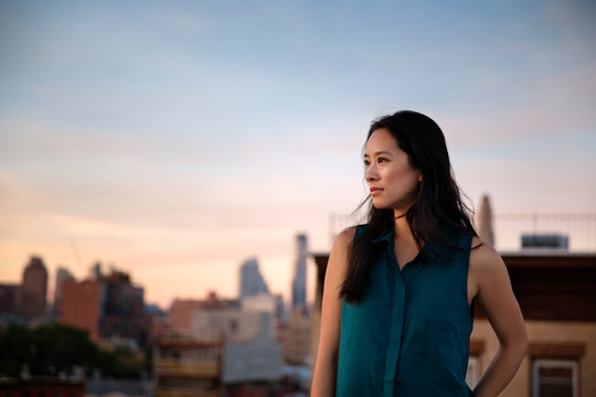 Woman looking at sunset from rooftop