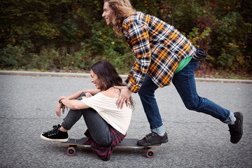 Young couple skateboarding in park © Cavan for Adobe