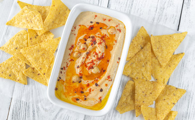 Bowl of hummus on the wooden table