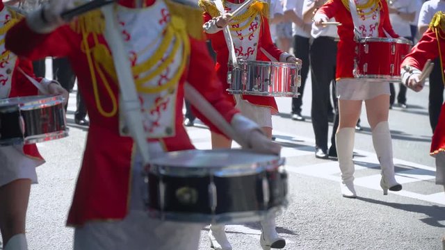 Young girls drummer in red at the parade. Street performance on the occasion of the holiday
