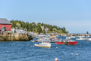Fototapeta na wymiar New England Harbor in Maine with a Lobster Boat Anchored in a Bay