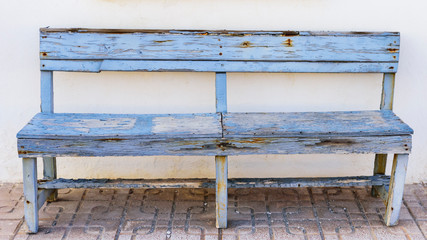 old wooden bench of blue color spoiled by the passage of years