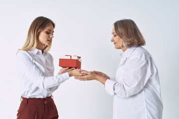 doctor giving gift to senior woman