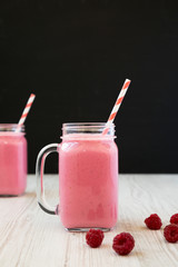 Raspberry smoothie in glass jars, side view. Close-up. Selective focus.