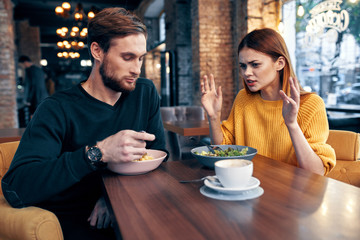 young couple having breakfast in cafe