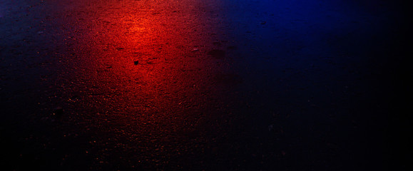 Background of wet asphalt with neon light. Blurred background, night lights, reflection. Night city, dark street.