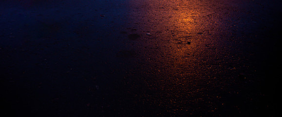 Background of wet asphalt with neon light. Blurred background, night lights, reflection. Night...
