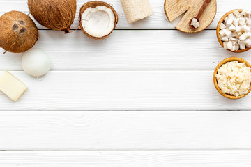 Homemade organic cosmetics with coconut on white wooden background top view mock up