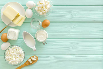 Breakfast on farm with dairy products on mint green wooden background top view space for text