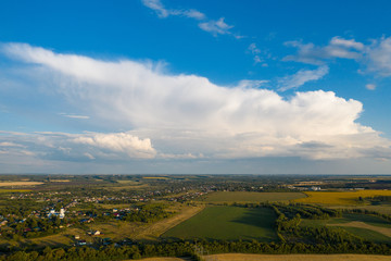 Aerial panorama of countryside summer green meadows and blue sky with clouds, beautiful rural fields