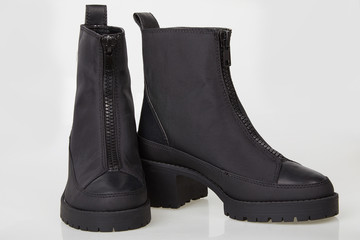 Pair of black female boots with zipper isolated on white. Ankle boots in black. Female black boots on white background