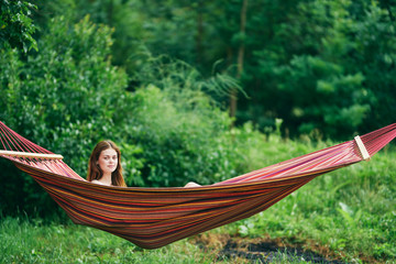 young woman relaxing in hammock