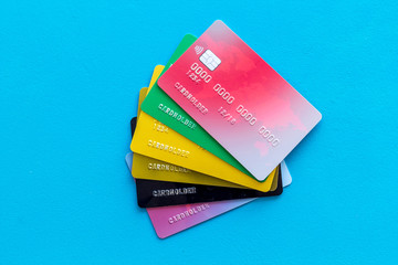 business with credit cards on office desk blue background top view
