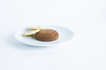 Two cookies on a white plate isolated