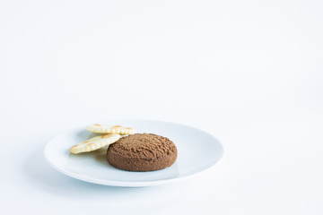 Two cookies on a white plate isolated