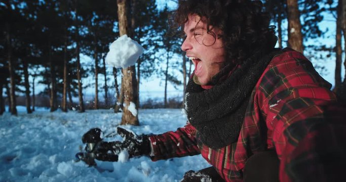 Young tourist holding a camera and make some selfie video in the middle of the snowy forest enjoying the moment very charismatic on a winter time