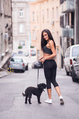 A young girl jogging with her dog