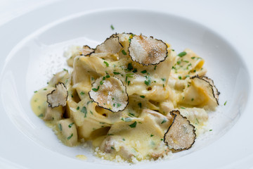 pasta with porcini mushrooms and truffle on old wood background
