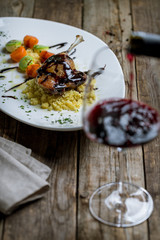 Duck leg confit on wooden background