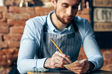 young man writing in notebook