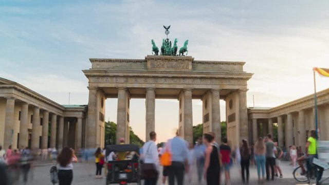 Day-to-night Hyperlapse with a long exposure crowded square with tourists in front of the Brandenburg Gate Berlin Germany