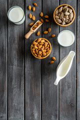 Healthy snack with almonds for milk on wooden background top view mock up