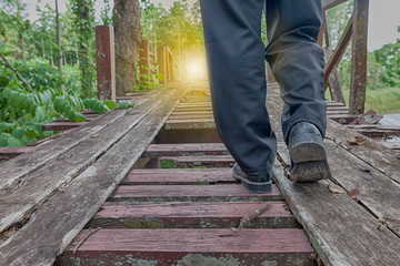 Pathway  to success concept a man walk on broken wood bridge with space area for write some text on  background meaning walk to success concept sometime the way don't not  convenient
