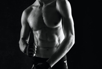 Fototapeta na wymiar muscular bodybuilder posing on black background
