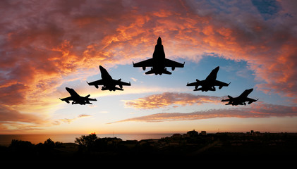 fighter flying in the sky at sunset - obrazy, fototapety, plakaty