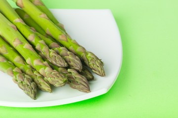 Asparagus on the Plate on Green Background