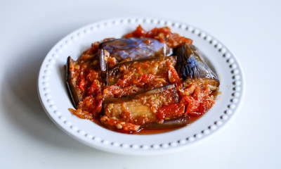 Terong balado (eggplants with chili sauce) on white background. Indonesian cuisine from Padang, West Sumatra.