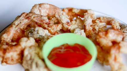 Fried shrimp and tomatoes sauce on white background.