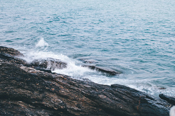 Danger sea wave crashing on rock coast with spray and foam in Thailand