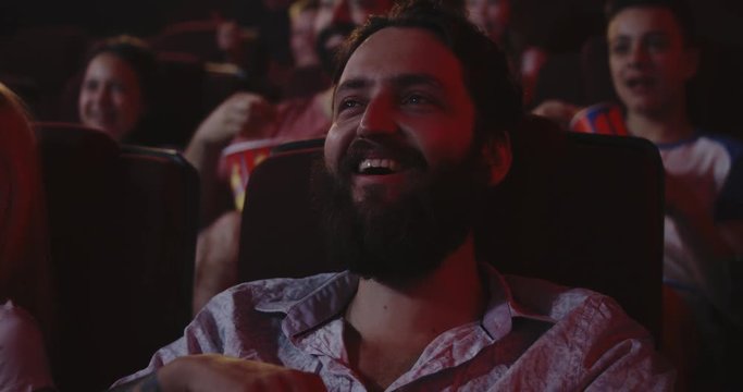 Young man watching movie in cinema