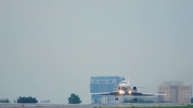 Business jet is taking off at sunset. Front view